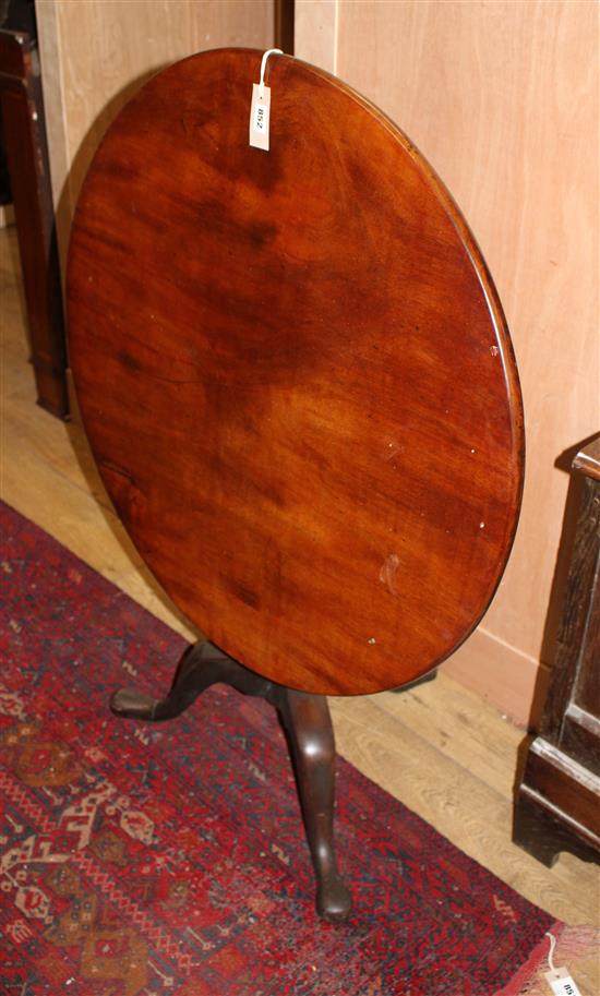 A George III mahogany circular tilt top table on pillar and tripod base, Diameter 84cm, H.71cm